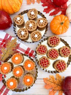 three pies with waffle holes on them and some pumpkins in the background