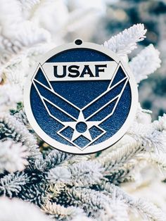 an ornament hanging from the side of a christmas tree that says usaf