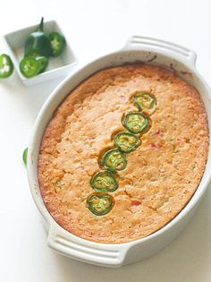 a casserole dish with green peppers in it on a white counter top,