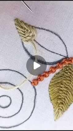 the video shows how to make an embroidered leaf with yarn and thread, as well as stitch