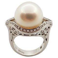 Pearl with Diamond 0.30 carat Ring set in 18 Karat White Gold Settings Width: 2.4 cm Length: 1.6 cm Ring Size: 53 Total Weight: 14.0 grams Pearl: 14.4 mm "We first opened doors in 1980 when it was then situated in the vicinity of the Victory Monument; a small and modest storefront with a couple of counters. From its humble beginnings to where it stands today, our company has proven its abilities as a jeweler. Since the beginning, we have been supplying fine quality pieces to dealers, wholesalers 1950s Ring, Diamond Ring Set, Tahitian Black Pearls, Pearl And Diamond Ring, White Gold Set, Diamond Ring Settings, Pearl Diamond, Round Brilliant Cut Diamond, Pearl Ring