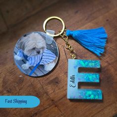 a keychain with a photo of a dog and the letter e on it