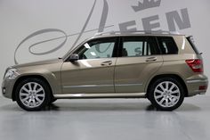 a beige mercedes benz suv parked in a garage