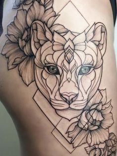 a woman's thigh with an abstract tattoo design on the side, depicting a fox and flowers