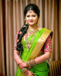 a woman in a green sari and gold jewelry