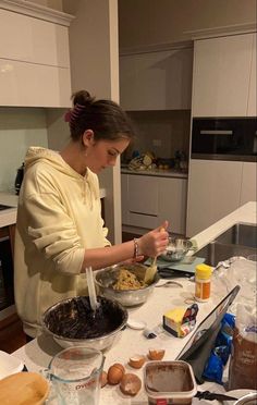 a woman is preparing food in the kitchen