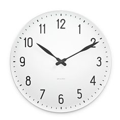 a white clock with black hands and numbers on the face is shown against a white background