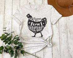 a t - shirt that says, fluent fowl hanger on it