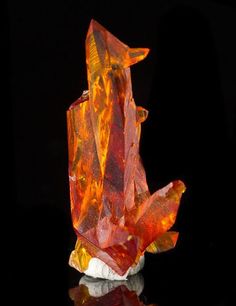 an orange piece of glass sitting on top of a table