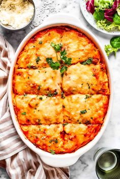 a casserole dish with meat and cheese in it on a marble countertop