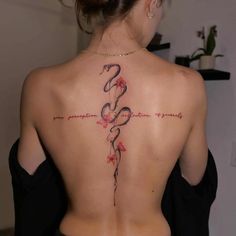 a woman with a cross tattoo on her back