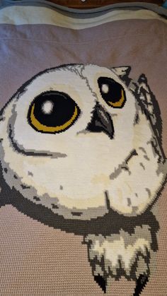 an owl made out of legos on a bed