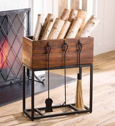 a wooden crate filled with bread on top of a hard wood floor next to a fire place