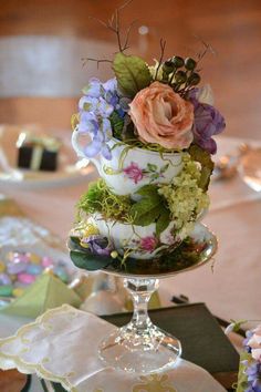 there is a cake that has flowers on the top and side of it with moss