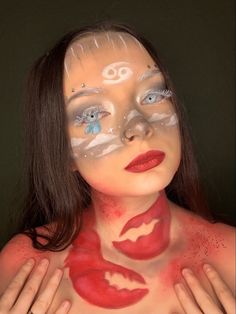 a woman with makeup painted on her face and hands around her body, posing for the camera