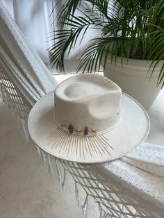 ꧁𓊈 Berghat𓊉꧂ Unveil the mystique with our Oracle Cosmic Fedora Hat, the perfect boho festival accessory for your next adventure. Designed in Tulum Alchemist style, this hat complements any whimsical wardrobe and sets you apart in any crowd. - **Unique Design Crafted for the free spirit, blending tribal elements with a modern twist. - **Material Made from breathable, eco-friendly materials ensuring comfort and sustainability. - **Size Available in various sizes for a perfect fit--because everyo Luxury Handmade Fedora For Festivals, Luxury Vintage Hat Bands For Festivals, Cheap Bohemian White Hats, Cheap Fedora Sun Hat For Festival, Luxury Summer Festival Cowboy Hat, Boho Bridesmaid Hats, Luxury Artisan Hats For Festival, Luxury Fedora Hat For Festivals, Luxury Western Style Festival Hats