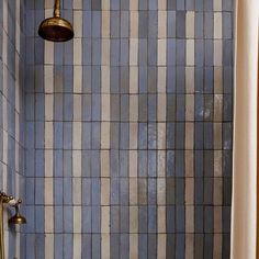 a bath tub sitting under a faucet next to a shower head in a bathroom