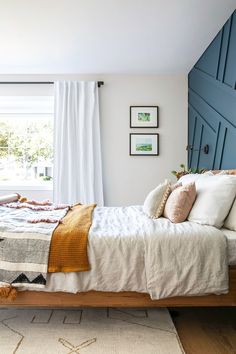 a bedroom with white walls and blue shutters