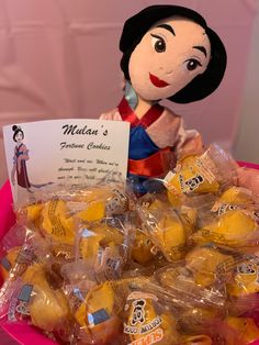 a pink basket filled with lots of yellow candies