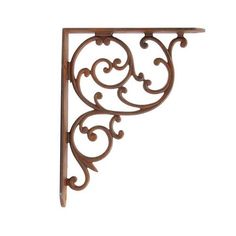 an ornate iron shelf bracket on a white background