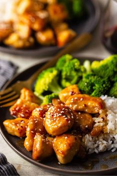 a plate with chicken, broccoli and rice on it next to a fork