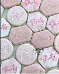 pink and white cookies with hello kitty written on them are arranged in the shape of hexagons