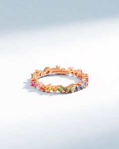 Crafted in 18-karat gold, this radiant band is meticulously crafted with princess-cut rainbow sapphires, each stone precisely set to create a constellation of brilliance that encircles your finger. The vibrant gold setting is a perfect canvas for the rainbow sapphires. Details 18k rose gold or yellow gold 1.18 carats of princess-cut rainbow sapphires 3.3mm width Ref: BAR1033RS Luxury Rainbow Cubic Zirconia Jewelry, Rainbow Wedding Ring, Sapphire Eternity Band, Rainbow Sapphires, Ruby Sapphire, Tennis Necklace, Jewelry Tray, Eternity Band, Eternity Bands