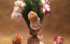 a vase filled with lots of different types of flowers on top of a cloth covered table