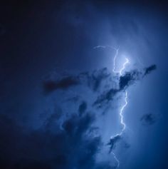 a large cloud with lightning in the sky