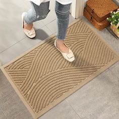 a woman is standing on the door mat