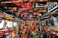 a restaurant filled with lots of wooden tables and chairs