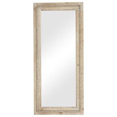 a white framed mirror sitting on top of a wall