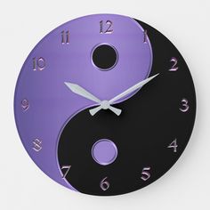 a purple and black yin - yang clock with numbers on the face is shown in front of a white background