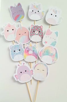 a bunch of stickers that are on top of a white table with some animals