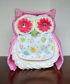 an owl purse with pink flowers on it