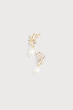 When you need to add some sophisticated shine to your big day look, the Lulus Seeking Elegance Gold Cubic Zirconia Pearl Stud Earrings are the perfect accessory for such a special occasion! These delicate yet stunning earrings feature shiny, gold-toned settings that shape a cluster-style design of dazzling cubic zirconia rhinestones (in varying shapes and sizes), while an attached faux pearl charm adds a chic finish. Post backs. 0. 75" long. 60% Brass, 30% Acrylic, 10% Cubic Zirconia. Imported. Pear Drop Earrings, Bridal Jewelry Pearl Earrings, Dainty Pearl Earrings, Bridal Pearl Earrings, Bridal Earrings Pearl, Gold Pearl Earrings, Cubic Zirconia Earrings, Pearl Charms, Bridal Pearls