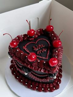 a heart shaped cake with cherries on top