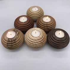 five wooden candles are arranged in a pyramid