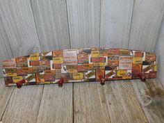 an old skateboard is sitting on a wooden floor next to a wall that has been painted orange and yellow