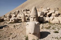 an ancient sculpture in the desert near some rocks