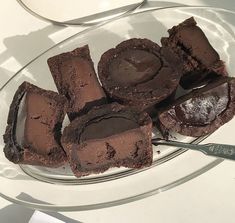 there are chocolate brownies on the glass plate