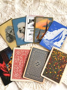 several playing cards are laid out on a lace tablecloth with the same pattern and colors