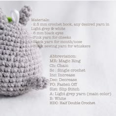 a crocheted stuffed animal sitting on top of a white sheet with words written below it