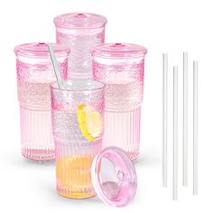 four glasses with drinking straws and two cups with lids