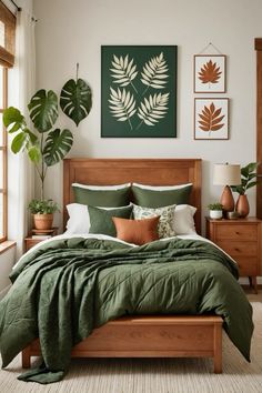 a bed with green comforter and pillows in a bedroom next to two potted plants