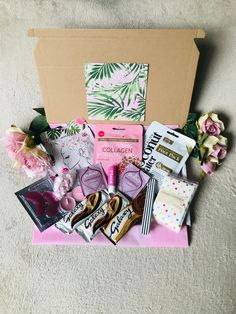 a box filled with lots of different types of candy and candies on top of a carpet