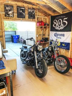 two motorcycles are parked in a garage