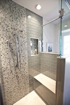 a walk in shower sitting inside of a bathroom