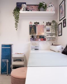 a bed room with a neatly made bed and lots of pictures on the wall above it