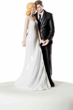 a wedding cake topper with a bride and groom